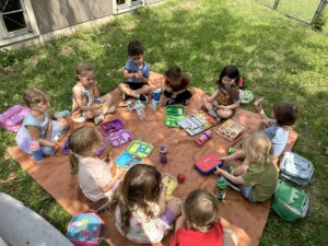 Children having a picnic outside Trinity CDC
